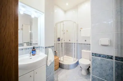 a bathroom with a sink and a toilet and a shower at Prague Days - Maisonette Retreat with Terrace, AC and TV Tower View in Prague
