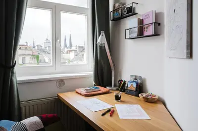 a desk in a room with a window at Prague Days - Maisonette Retreat with Terrace, AC and TV Tower View in Prague