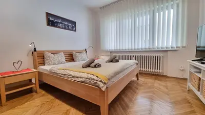 a bedroom with a large bed and a television at Stylish Flat in Top Area ! New with Great Access in Prague