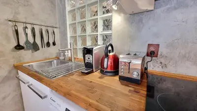 a kitchen with a counter top with a toaster and a sink at Stylish Flat in Top Area ! New with Great Access in Prague