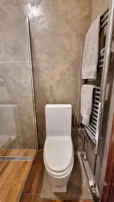 a bathroom with a white toilet and a shower at Stylish Flat in Top Area ! New with Great Access in Prague