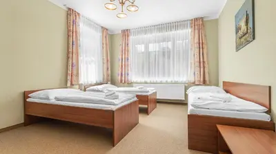 a bedroom with two beds and a window at Hotel Samechov - konferenční hotel in Samechov