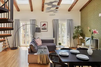 a living room with a couch and a table at Prague Days - Maisonette with AC and 2 Bathrooms in New Town in Prague
