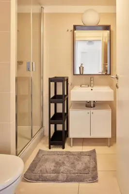 a bathroom with a sink and a mirror and a shower at Prague Days - Maisonette with AC and 2 Bathrooms in New Town in Prague