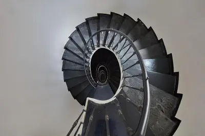 a spiral stairwell in a museum with a spiral at Prague Days - Maisonette with AC and 2 Bathrooms in New Town in Prague