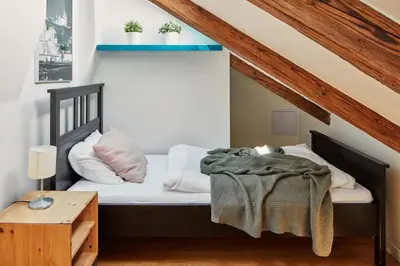 a bedroom with a bed and a table at Prague Days - Maisonette with AC and 2 Bathrooms in New Town in Prague