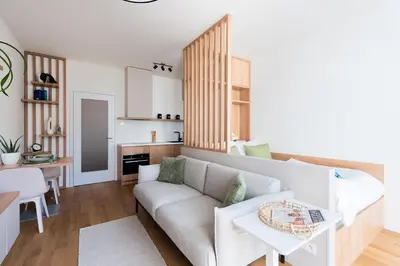 a living room with a couch and a table at Olive Garden Apartment with Garage in Prague