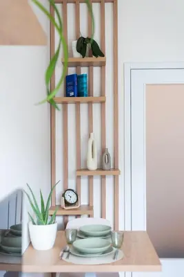 a table with plates and a clock on a shelf at Olive Garden Apartment with Garage in Prague