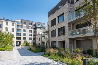 an apartment building with a sidewalk in front of it at Olive Garden Apartment with Garage in Prague