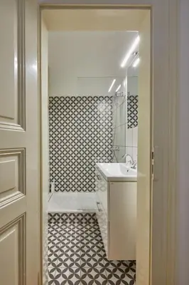 a bathroom with a white sink and a shower at Prague Days - Deluxe Apartment with Balcony overlooking gardens in Lesser Town in Prague