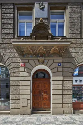 a building with a wooden door in front of it at Prague Days - Deluxe Apartment with Balcony overlooking gardens in Lesser Town in Prague