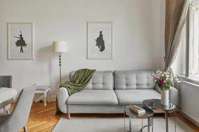 a living room with a couch and a table at Prague Days - Deluxe Apartment with Balcony overlooking gardens in Lesser Town in Prague