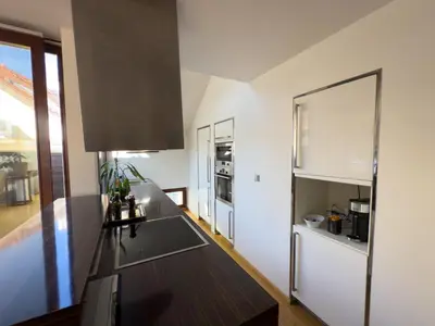 a kitchen with a counter top and a refrigerator at Loft-style& Modern Apartment in the center of Prague in Prague