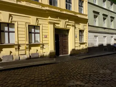 a yellow building with a door on a street at Loft-style& Modern Apartment in the center of Prague in Prague