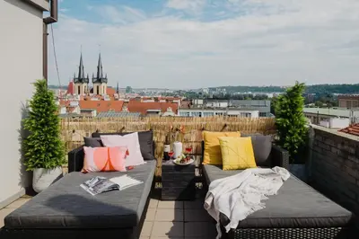 a balcony with two beds and a view of the city at Prague Days - Cozy Studio with Rooftop Terrace in hip Letná in Prague