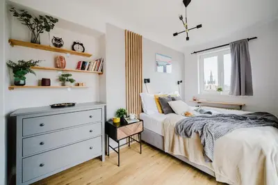 a bedroom with a bed and a dresser at Prague Days - Cozy Studio with Rooftop Terrace in hip Letná in Prague
