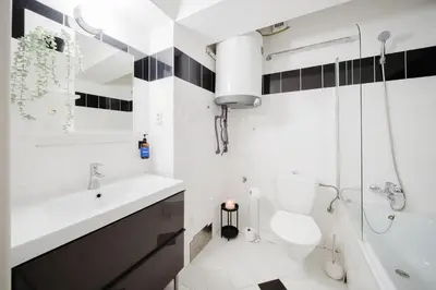 a bathroom with a sink and a toilet and a tub at Prague Days - Loft with Terrace and Prague Castle View by Vltava River in Smíchov in Prague