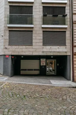 a building with two garage doors in front of it at Prague Days - Studio with Balcony and Garage Parking in Smíchov in Prague