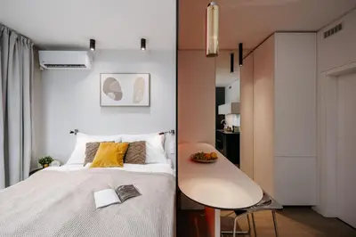 a small bedroom with a bed and a table at Prague Days - Studio with Balcony and Garage Parking in Smíchov in Prague