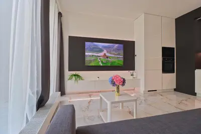 a living room with a vase of flowers on a table at Luxury apartment in Smíchov in Prague