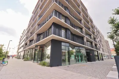 a large building with glass windows on a street at Luxury apartment in Smíchov in Prague