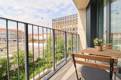 a balcony with a bench and a view of a street at Luxury apartment in Smíchov in Prague