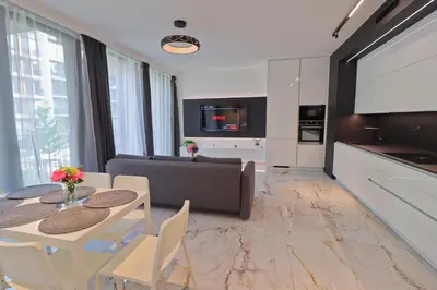 a living room with a table and a couch at Luxury apartment in Smíchov in Prague