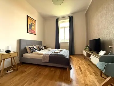 a bedroom with a bed and a television in it at Peaceful 1Bedroom Flat at Local side of the Center in Prague
