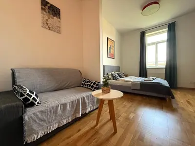 a living room with a couch and a table at Peaceful 1Bedroom Flat at Local side of the Center in Prague