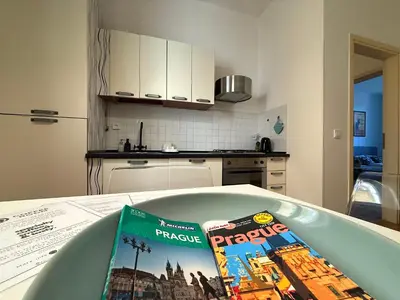 two books sitting on a table in a kitchen at Peaceful 1Bedroom Flat at Local side of the Center in Prague