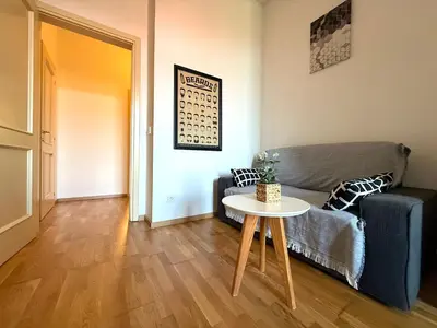 a living room with a couch and a table at Peaceful 1Bedroom Flat at Local side of the Center in Prague