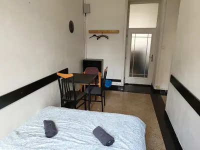 a bedroom with a bed and a table and a chair at Comfy 2rooms Flat 4 persons & Parking in Prague