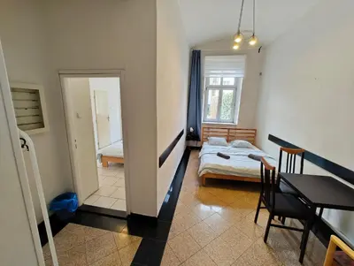 a room with a bed and a table and a bedroom at Comfy 2rooms Flat 4 persons & Parking in Prague
