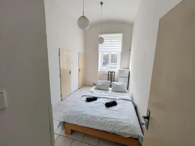 a bedroom with two beds and a window at Comfy 2rooms Flat 4 persons & Parking in Prague