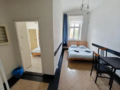 a bedroom with a bed and a table and a mirror at Comfy 2rooms Flat 4 persons & Parking in Prague