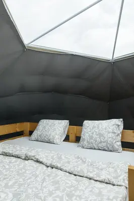 a bed in a tent with two pillows on it at Glamping Prague Louka in Prague