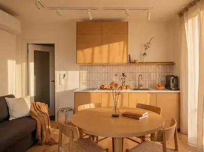 a living room with a table and a kitchen at Turnkey I Henry's Tower Apartments in Prague