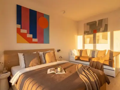 a bedroom with a bed with a book on it at Turnkey I Henry's Tower Apartments in Prague