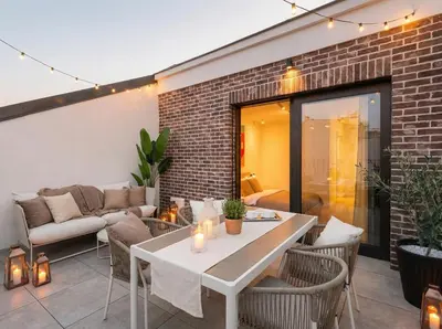 a patio with a couch and a table at Turnkey I Henry's Tower Apartments in Prague