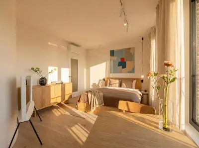 a bedroom with a bed and a table in a room at Turnkey I Henry's Tower Apartments in Prague