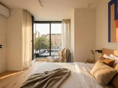 a bedroom with a bed and a large window at Turnkey I Henry's Tower Apartments in Prague
