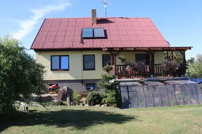 a house with a red roof and a fence at Apartment Příbram in Příbram