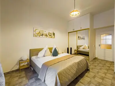 a bedroom with a large bed and a couch at Quiet Central Station Apartments in Prague