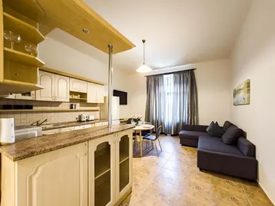 a kitchen and living room with a couch and a table at Quiet Central Station Apartments in Prague