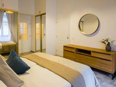 a bedroom with a large bed and a mirror at Quiet Central Station Apartments in Prague