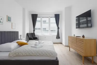 a bedroom with a bed and a dresser and a window at Apartment with 2 bedrooms with kitchen near metro in Prague