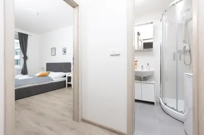a bathroom with a mirror and a sink and a bed at Apartment with 2 bedrooms with kitchen near metro in Prague