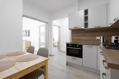 a kitchen with a wooden table and a dining room at Apartment with 2 bedrooms with kitchen near metro in Prague