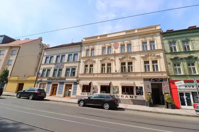 two cars parked in front of a building on a street at Botič Gardenia Residences Prague in Prague