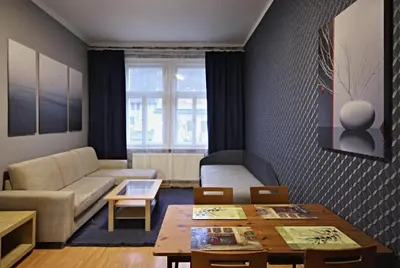a living room with a couch and a table at Botič Gardenia Residences Prague in Prague